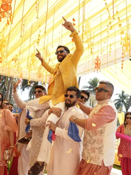 The groom's squad lifting him up on their shoulders. The energy and excitement of an Indian Haldi ceremony is unmatched.