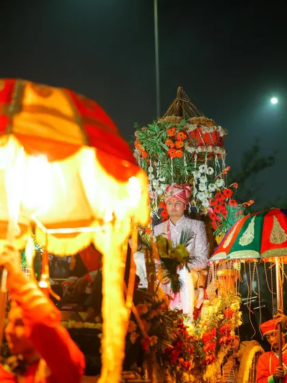 A candid shot of the groom during the procession, capturing the atmosphere of the night.