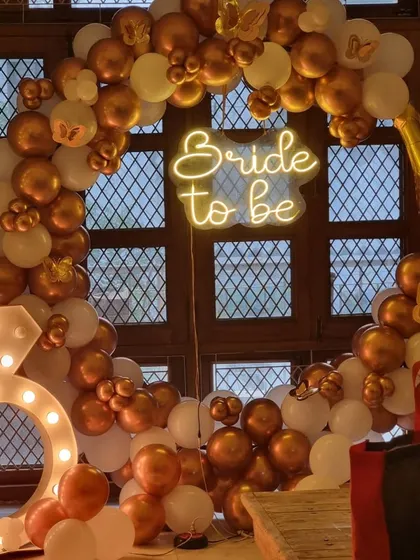 A closer look at our popular indoor "Bride to be" setup, showing the champagne bottle balloon and the glowing diamond ring marquee light.