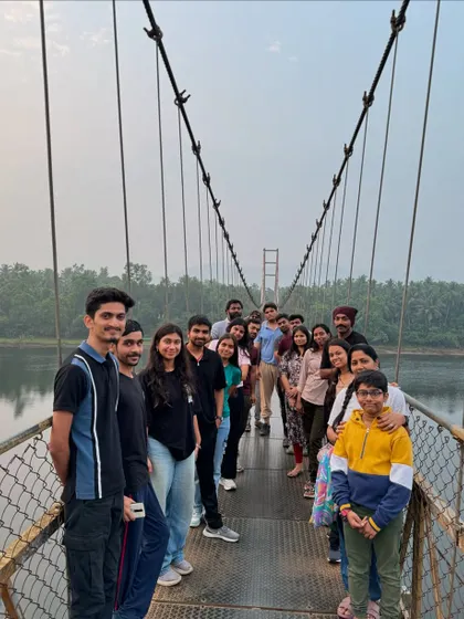 Our group posing on a picturesque suspension bridge over the river during our Gokarna trip, a perfect spot for photos.