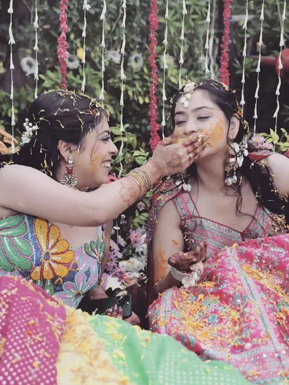 Sisters and friends sharing a fun, messy moment during the Haldi ceremony. It’s these personal interactions that make the event so special, and I make sure to capture them.