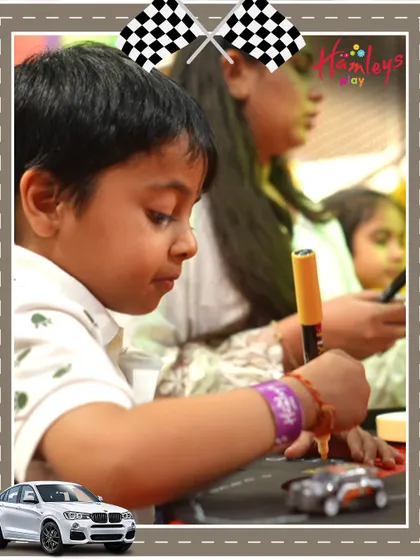 A young racer is deep in concentration as he customizes his car at our Mini Racers event. These creative activities are designed to build confidence and spark curiosity in a fun setting.