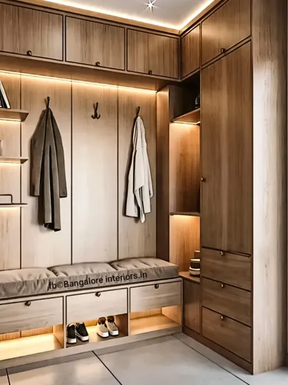 This L-shaped entryway unit makes perfect use of a corner space. It provides a seating bench, coat hooks, and ample shoe storage in drawers and open cubbies, all in a warm wood finish.