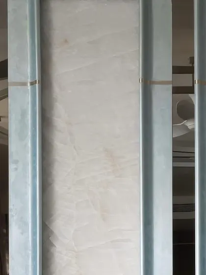 Lines are the basic elements of design. Here, vertical metal channels create a rhythmic pattern, with the reflections in the polished surfaces adding another layer of visual complexity and depth.