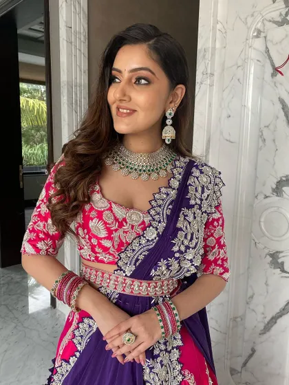 A close-up of the pink and purple lehenga look. The soft waves and diamond jewelry complete this elegant and modern style.