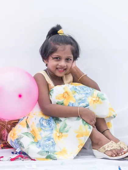 A moment of quiet joy in a pastel floral dress. The soft colors and comfortable fit make it perfect for enjoying a party from start to finish.