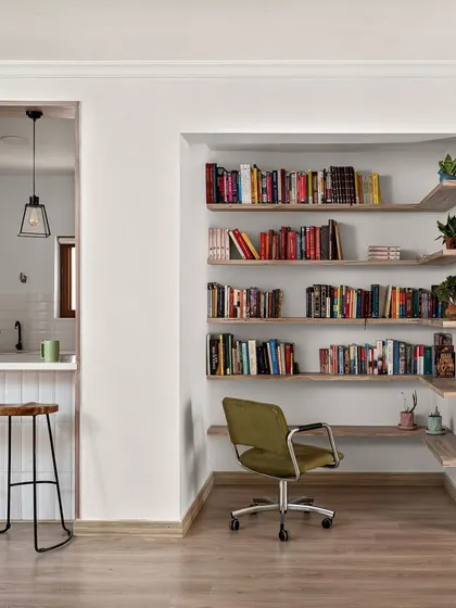 In our "Between Shades of Grey" project, we carved out this functional study nook, complete with a built-in desk and open shelving, connected to a breakfast bar for a multi-purpose living space.