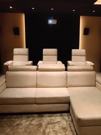 A closer look at the seating arrangement in this custom media room. The combination of a large sofa and individual recliners provides a versatile and comfortable environment for long movie marathons or casual viewing.