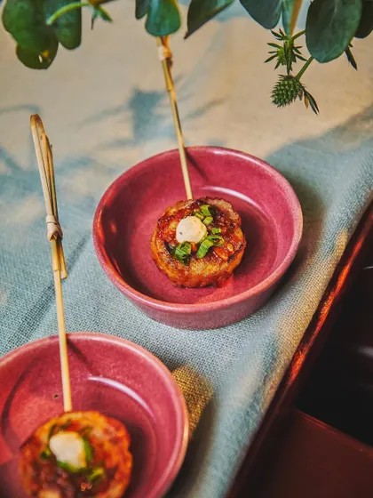A simple yet delicious bite. These Chicken 65 Pinwheels are served with a smoked raita, offering a familiar flavor in a new and interesting form.