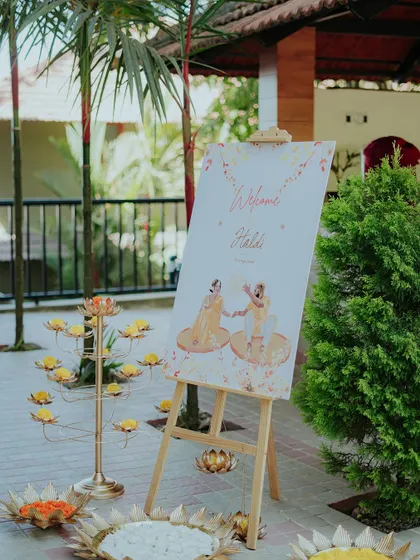 A custom caricature welcome board adds a fun and personal touch to this Haldi ceremony. Surrounded by vibrant decor, it sets the tone for a day of love and laughter.