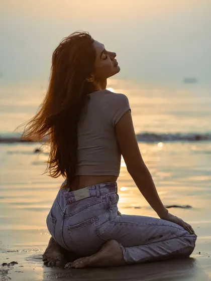 The model soaking in the last rays of sun. This image conveys a sense of peace and connection with nature.