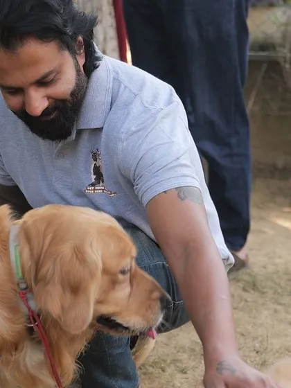 Arun sharing a moment with a beautiful Golden Retriever during a dog party. These events are as much fun for us as they are for the dogs.
