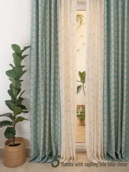 The Dahlia print in a soft sage green is paired with a Sapling Nile Blue sheer. This is a beautiful example of how to mix subtle patterns and colors for a harmonious, nature-inspired feel.