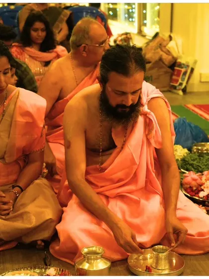 A priest performs a ritual during the Janmashtami puja. We believe in honoring traditions with authenticity and reverence, creating a sacred space for everyone to experience the divine.