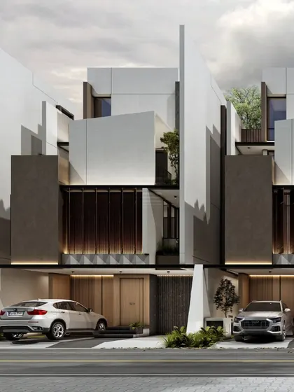 Another view of the row houses, showing how the symmetrical facades create a cohesive streetscape. Each home features a sheltered entrance and private outdoor spaces, balancing community living with individual privacy.