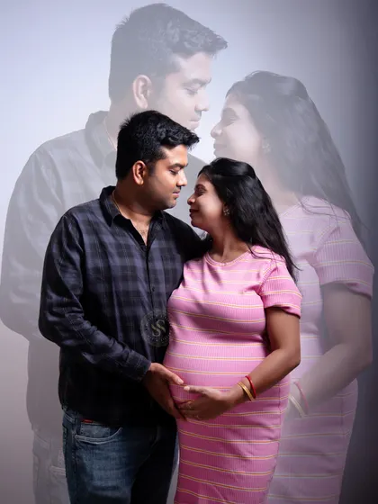 A creative double-exposure effect used in a studio portrait to add an artistic and dreamy touch to this couple's maternity photo.