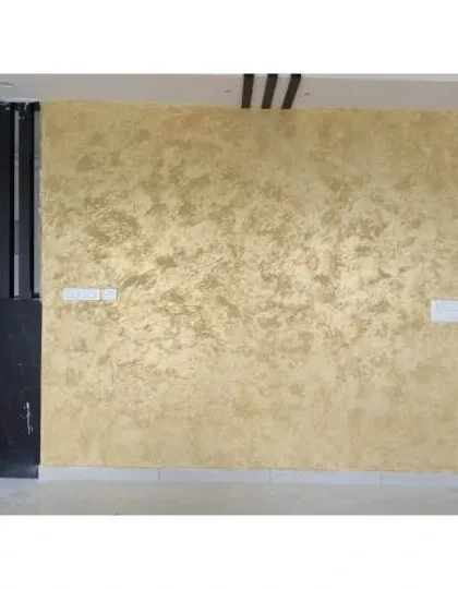A luxurious gold metallic textured finish on a large accent wall, creating a radiant and opulent effect that catches the light beautifully.