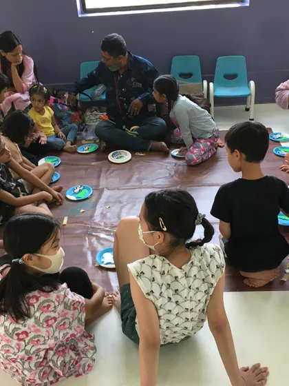 Arts and crafts are a key part of my camps. Here, children are gathered for a creative session, where they can express themselves and develop fine motor skills.