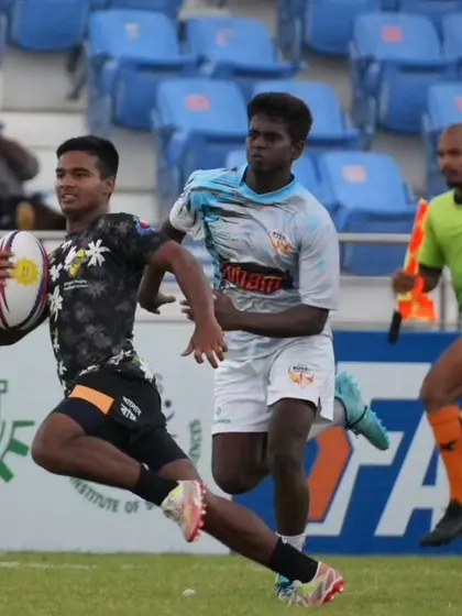 A young rugby player breaks away from the defense. These national championships are a crucial platform for young talent to get noticed and gain experience.