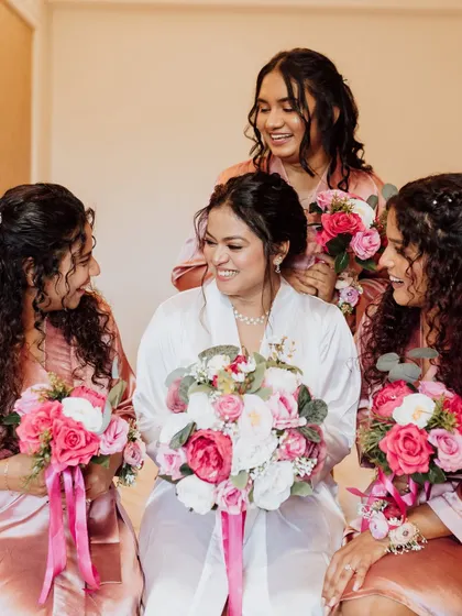 A beautiful shot of the bride with her bridesmaids, all in matching robes. It's a special moment before the ceremony begins.