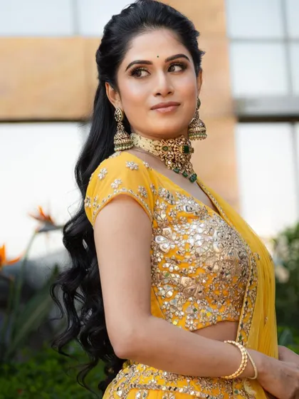 A bright and sunny look for a daytime Mehendi or Haldi ceremony, featuring a vibrant yellow lehenga and fresh, glowing makeup.