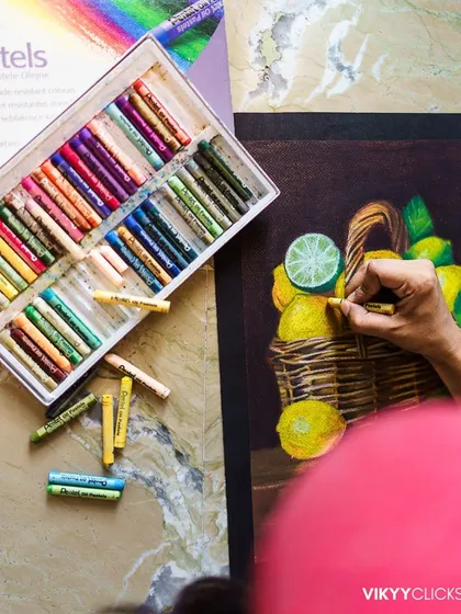 A top-down view of me working with oil pastels. I love capturing these moments that show the tools and materials behind the finished artwork.