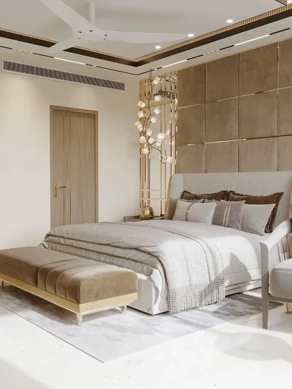 Another view of a beige and brown bedroom, showcasing a plush, fabric-paneled back wall with elegant light fixtures. This design is all about creating a warm, cozy, and luxurious retreat.