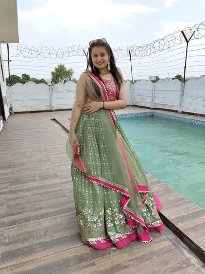 This light green lehenga with a contrasting pink blouse is a fresh and pretty option for a daytime Mehendi function.