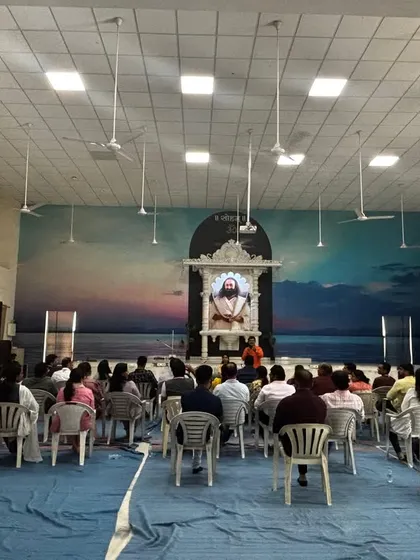 A wide shot of our Ahmedabad Matrimony Meet, where seekers gathered in a serene hall under the gaze of Gurudev's portrait. The atmosphere was one of reflection and open-hearted connection.
