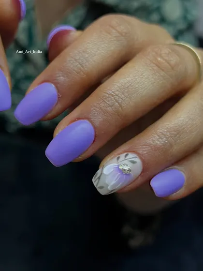 A matte purple base with a translucent 3D flower and a touch of sparkle. I love teaching how to combine different textures and finishes in one design.