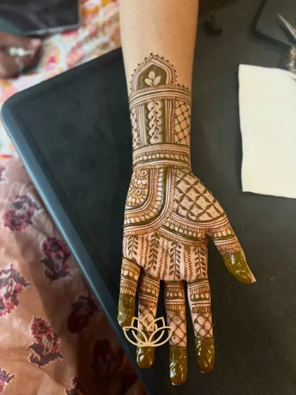 A close-up of a half-hand bridal design, perfect for sangeet or engagement ceremonies. The pattern features intricate net-work and a beautifully detailed wristband.