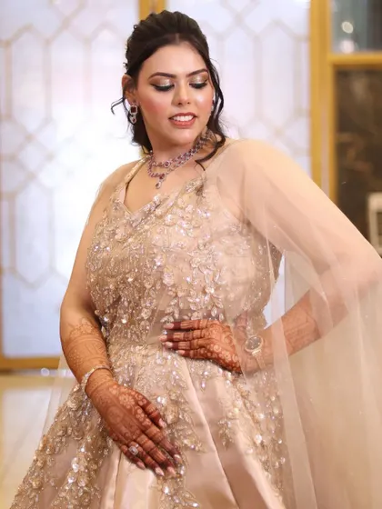 Another elegant pose, with the bride's hand on her hip, showcasing her confidence and the beauty of her gown.