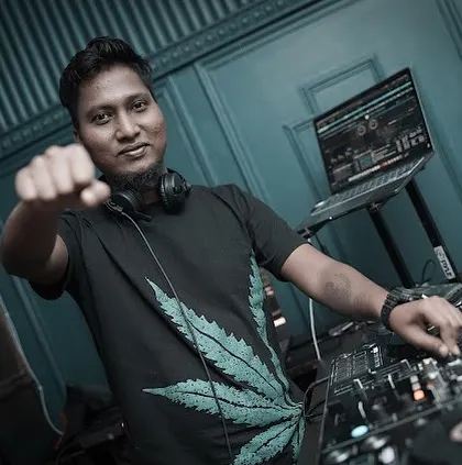 A powerful shot from behind the decks, ready to drop the next beat. This is the moment of anticipation before the energy of a track is unleashed.