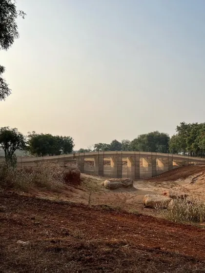 A mock-up for a bridge, designed by a collaborator and constructed from jute fabric, creates a striking installation on our site in Aziznagar. This artistic approach to prototyping helps us visualize the form and scale of a major landscape feature.