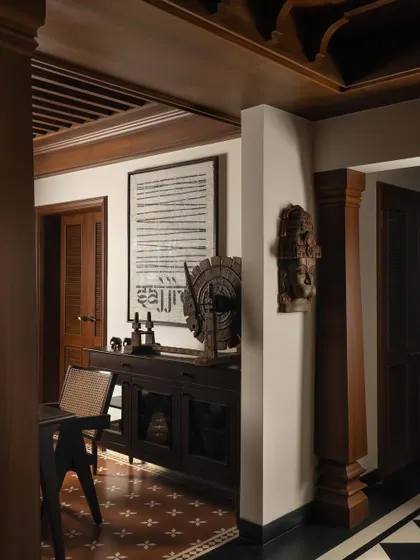 A curated corner in the House of Gond, where art, artifacts, and furniture are composed in careful dialogue. The checkered Karaikudi floor tiles provide a vibrant, graphic base for the ensemble.