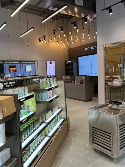 The retail and reception area of the Enrich salon. We designed the layout with wide aisles and clear product displays to encourage browsing and create a seamless transition from retail to the service area.
