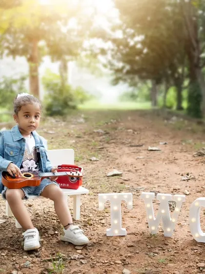 A cool and casual outdoor birthday shoot for a two-year-old. The natural path and trees create a beautiful, rustic backdrop.