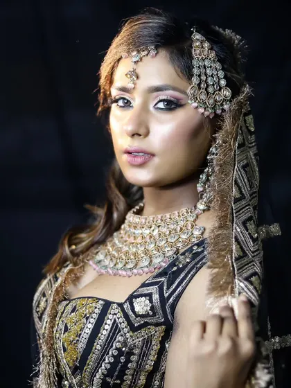 This full-length shot shows the entire bridal ensemble, a testament to the student's ability to create a cohesive and stunning look.