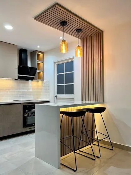Another view of the compact kitchen with a breakfast bar, showing how it creates a functional dining space without taking up too much room.