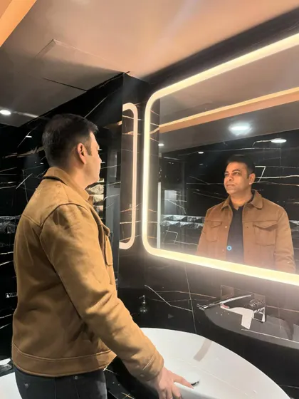 The reflection in the mirror shows the level of detail and finish throughout the bathroom.