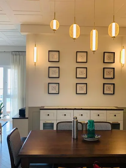 Dinner parties just got an upgrade with this chic setup. A bright and airy dining space with modern lighting and a gallery wall.