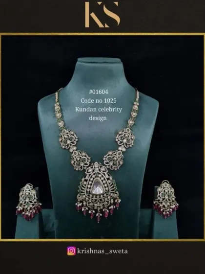 An oxidized version of our celebrity Kundan set with ruby accents. This piece combines a vintage feel with a grand design.