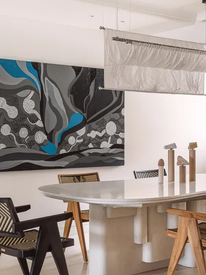 The dining space at Kanso House, where art and design converge. A stunning 'Starry Nights' inspired painting and a sculptural fabric light create an atmosphere of engrossing beauty, perfect for intimate dinners and shared moments.
