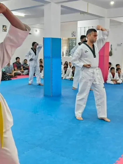 A student demonstrates a high block during her Poomsae.
