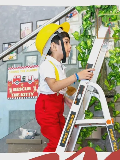 A repeat image of the birthday boy on the ladder.