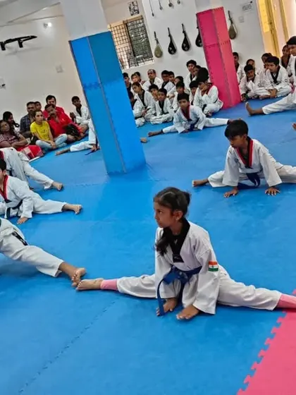 A student demonstrates great flexibility during a warm-up.