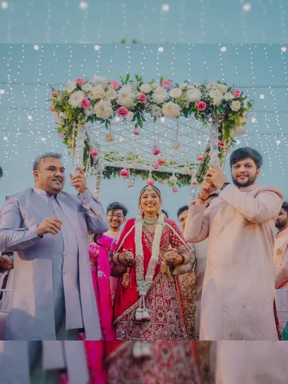 The bride's joyful entrance under a beautiful floral 'phoolon ki chadar' held by her brothers.