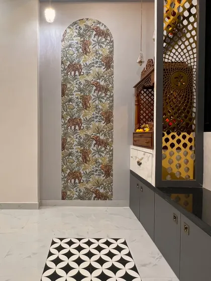 Another angle of the elephant-themed prayer area, highlighting the beautiful floor tiles and the detailed jali work on the cabinet.