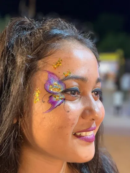 A purple butterfly with gold glitter accents, a beautiful color combination.