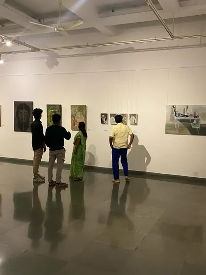 A group of visitors looking at the varied works in the 'ME, AMMA, WE' exhibition.